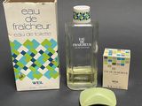a bottle of eau de fraicheur next to a box of perfume