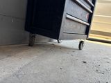 an image of a black box with wheels on the ground