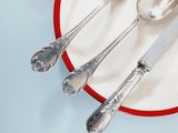 a plate with silverware on it and a fork and knife