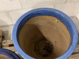 two blue pots sitting next to each other on a pallet