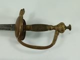 a sword that is laying on a white surface