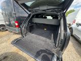 the back of a van with its trunk open in a parking lot