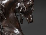 bronze statue of a horse with a rider on it ' s back