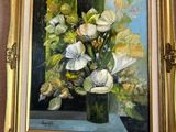 une peinture de fleurs dans un vase accrochée au mur