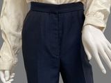 an image of a mannequin wearing a white shirt and blue pants