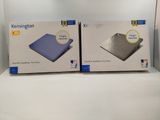 two boxes of blue and white items sitting on a white surface