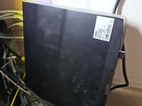 a computer monitor sitting on top of a black desk