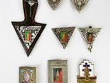 several different types of badges are displayed on a white surface