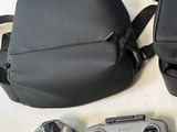 a camera, a camera case, a cell phone, and a camera bag on a table