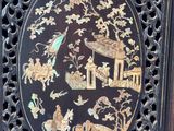 a picture of a black and gold plate with animals and birds on it