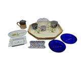 a small tray with a tea set on it and a cup and saucer