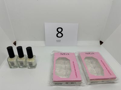 three bottles of nail polish and a box of nail polish