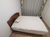 un petit lit dans une petite chambre avec une fenêtre