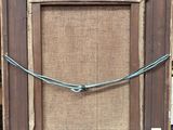 an old picture frame with a rope hanging from it ' s side