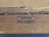 an old wooden box with a label on it