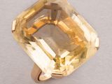 an image of a yellow topazte ring on a white surface