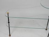 a glass and brass coffee table with a curved glass top