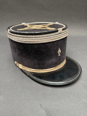 an old black hat with a gold band on top of it