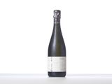 a bottle of wine sitting on top of a white table