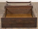 an old wooden box is open on a tile floor