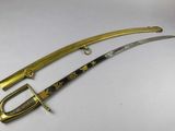 a close up of two swords on a white surface