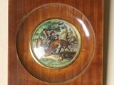 a picture of a picture of a man riding a horse on a plaque