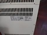a white air conditioner sitting on top of a wooden floor