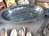 a silver plate with spoons and spoons on a table