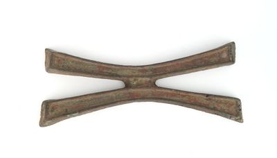 an image of a pair of old iron tongs on a white surface