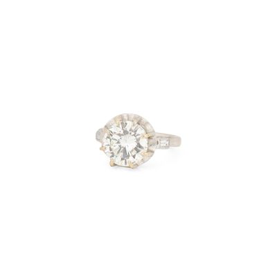 a close up of a diamond ring on a white background
