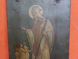 tableau représentant un saint avec un chien posé sur une table rouge