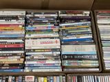 a lot of dvds in a box on the floor
