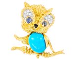 une photo d'une broche en forme de chouette en or ornée d'une pierre turquoise