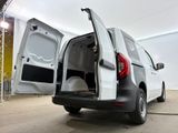 a white van with its doors open in a garage