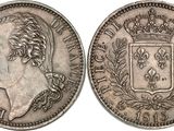 a silver coin with a crown on the front and a crown on the back