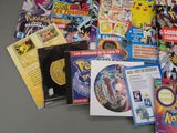 a lot of pokemon dvds and cds on the table