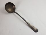 a spoon and a spoon rest on a white surface