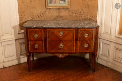 une commode au plateau en marbre, placée dans un coin de la pièce