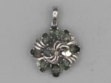 an image of a silver pendant with black and white stones