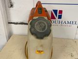 an orange and white vacuum cleaner sitting on top of a wooden table
