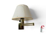 a lamp that is on the wall next to a lamp shade