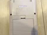 an old nintendo game console sitting on top of a wooden table