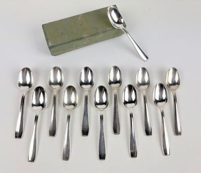 six spoons and a spoon rest on a table
