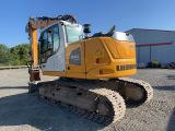 an image of a yellow and white bulldozer parked in a parking lot