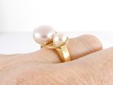 a close up of a person ' s hand with a ring on it