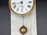 an image of a clock hanging from the side of a wall