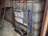 a large metal container with a blue hose in it