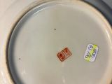 a white plate with a brown rim sitting on a table