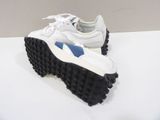 white and blue sneakers with black soles on a white surface
