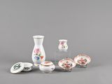 a group of small vases and bowls sitting on a table